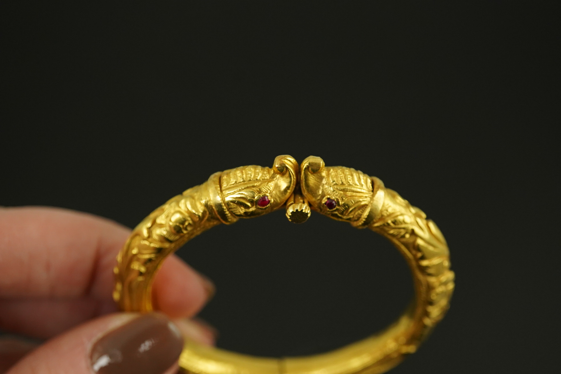 An antique Indian? high carat gold hinged bangle